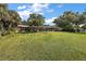 Spacious backyard with lush lawn, screened patio, and many ducks at 8 Se Ocale Way, Summerfield, FL 34491