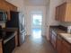 Functional kitchen featuring stainless steel appliances, wood cabinets and tile floors at 8590 Se 157Th Pl, Summerfield, FL 34491