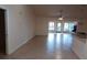 Open living room with tile flooring, neutral walls and a ceiling fan for efficient cooling at 8590 Se 157Th Pl, Summerfield, FL 34491