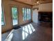 Cozy living room with tiled floor, natural light, and a stone fireplace at 8590 Se 157Th Pl, Summerfield, FL 34491