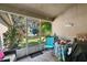 Relaxing screened porch with a view of the backyard, ceiling fan, and comfortable seating at 1039 Sandhill St, Groveland, FL 34736