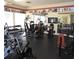 Community gym with exercise machines, weights, mirrored walls and television for residents at 11508 Westwood Blvd # 328, Orlando, FL 32821