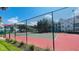 Community tennis court surrounded by fencing and greenery; apartment buildings in the background at 11508 Westwood Blvd # 328, Orlando, FL 32821