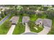 A bird's eye view shows the home nestled amongst mature trees in a manicured community at 5206 Fantasy Way, Leesburg, FL 34748