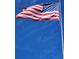 Close up of an American flag waving against a clear blue sky at 5206 Fantasy Way, Leesburg, FL 34748