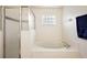 Clean bathroom featuring a soaking tub with glass block window and separate shower at 5206 Fantasy Way, Leesburg, FL 34748