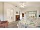Bright bedroom featuring a private ensuite bathroom, access to the outdoors, and ample closet space at 5206 Fantasy Way, Leesburg, FL 34748