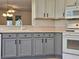 Bright kitchen featuring gray and white cabinetry, modern appliances, and a functional layout at 5206 Fantasy Way, Leesburg, FL 34748