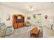 Bright living room with plush seating, a wooden entertainment center, and french doors to the outdoor space at 5206 Fantasy Way, Leesburg, FL 34748