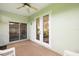 View of the screened porch showing access to the yard and the home's interior at 5206 Fantasy Way, Leesburg, FL 34748