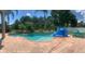 Inviting swimming pool with a waterfall feature and spacious patio at 6048 Tremayne Dr, Mount Dora, FL 32757