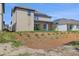 Exterior view of the home's backyard featuring a covered patio, young trees and new landscaping at 6224 Trailblaze Bnd, Saint Cloud, FL 34771