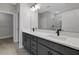 Modern bathroom featuring double sinks, sleek fixtures, vanity lighting and a tiled shower at 6224 Trailblaze Bnd, Saint Cloud, FL 34771