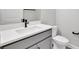 Stylish bathroom with modern sink, grey vanity, white countertop, and contemporary fixtures at 6224 Trailblaze Bnd, Saint Cloud, FL 34771