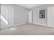 A neutral bedroom featuring carpet floors, a window, and white double-door closets at 6224 Trailblaze Bnd, Saint Cloud, FL 34771