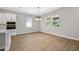 Dining area featuring hardwood floors and natural lighting with large windows at 6224 Trailblaze Bnd, Saint Cloud, FL 34771