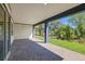 Covered patio with brick pavers and a view of the backyard with lush green grass at 6224 Trailblaze Bnd, Saint Cloud, FL 34771