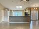 Galley style kitchen with stainless steel appliances and an island at 6410 Tildon Ct, Leesburg, FL 34748