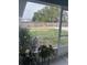 View of the backyard from the porch featuring a large grassy area and a wooden fence at 104 Turtle Run, Umatilla, FL 32784
