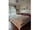 Bright and cozy bedroom features a large bed, a window and warm, natural light at 104 Turtle Run, Umatilla, FL 32784