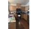 Kitchen with wooden cabinets, a stainless steel oven, microwave, and laminate countertops at 104 Turtle Run, Umatilla, FL 32784