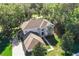 Two story home featuring a paved driveway and lush surrounding greenery under a clear sky at 24126 Plymouth Hollow Cir, Sorrento, FL 32776