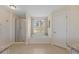 Bright bathroom with a shower, soaking tub under a window, and tiled floor, offering a relaxing retreat at 24126 Plymouth Hollow Cir, Sorrento, FL 32776