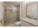 Modern bathroom showcases a glass-enclosed shower with decorative tile, a toilet, and a vanity at 24126 Plymouth Hollow Cir, Sorrento, FL 32776