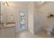 Bright bathroom features a tub and shower, toilet, and sink with a door to the pool area at 24126 Plymouth Hollow Cir, Sorrento, FL 32776