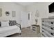 Cozy bedroom with a decorative dresser, mirror, and bed, creating a relaxing and stylish space at 24126 Plymouth Hollow Cir, Sorrento, FL 32776