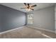 Carpeted bedroom with an accent wall, a window, and ample space for furnishings at 24126 Plymouth Hollow Cir, Sorrento, FL 32776