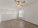 Bonus room or loft space features wood flooring, a ceiling fan, and natural light from a window at 24126 Plymouth Hollow Cir, Sorrento, FL 32776