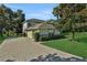 Exterior view of the home with brick driveway, manicured lawn, and lush landscaping, enhancing its charm at 24126 Plymouth Hollow Cir, Sorrento, FL 32776