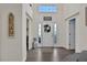 Bright foyer with high ceilings, stylish decor, and wood-look floors create a welcoming entrance at 24126 Plymouth Hollow Cir, Sorrento, FL 32776