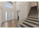 Inviting foyer with high ceilings and a staircase, creating an open and airy feel at 24126 Plymouth Hollow Cir, Sorrento, FL 32776