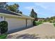 Attached three-car garage with a paved driveway that offers ample parking and curb appeal at 24126 Plymouth Hollow Cir, Sorrento, FL 32776