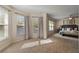 Sunlit main bedroom showcasing large windows with curtains and carpeting, inviting plenty of natural light at 24126 Plymouth Hollow Cir, Sorrento, FL 32776