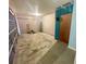 Unfinished basement with ladder, equipment, concrete floor, and painted accent wall with door at 1415 Harnden W Rd, Port Orange, FL 32129