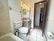 Bathroom featuring a bathtub and shower, toilet, and single sink vanity at 1415 Harnden W Rd, Port Orange, FL 32129
