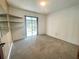 This cozy room features built-in shelving and a sliding glass door at 1415 Harnden W Rd, Port Orange, FL 32129