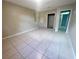 Spacious bedroom featuring tile flooring, with a walk-in closet and view of the hall at 1415 Harnden W Rd, Port Orange, FL 32129