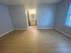 The primary bedroom features light wood floors and an attached bathroom with a vanity at 1415 Harnden W Rd, Port Orange, FL 32129