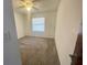 Bedroom boasts ceiling fan and neutral carpet at 1415 Harnden W Rd, Port Orange, FL 32129
