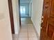Inviting entryway featuring ceramic tile, wood door, and a glimpse of the outdoor pool at 1415 Harnden W Rd, Port Orange, FL 32129