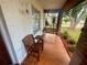 Charming covered front porch with a swing and comfortable seating, perfect for enjoying the outdoors at 1415 Harnden W Rd, Port Orange, FL 32129