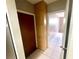 Hallway featuring ceramic tile floor and a large storage cabinet with light wood color at 1415 Harnden W Rd, Port Orange, FL 32129