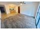 Open living room with ceiling fan, wood-look floors and carpet and natural light throughout at 1415 Harnden W Rd, Port Orange, FL 32129