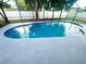 Sparkling blue pool with tiled edges in a screened-in outdoor enclosure at 1415 Harnden W Rd, Port Orange, FL 32129