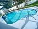 Enjoy this relaxing screened-in pool with tiled trim and a sun-drenched deck, great for entertaining at 1415 Harnden W Rd, Port Orange, FL 32129