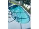 Sparkling screened-in pool with blue tile steps and a modern ladder at 1415 Harnden W Rd, Port Orange, FL 32129